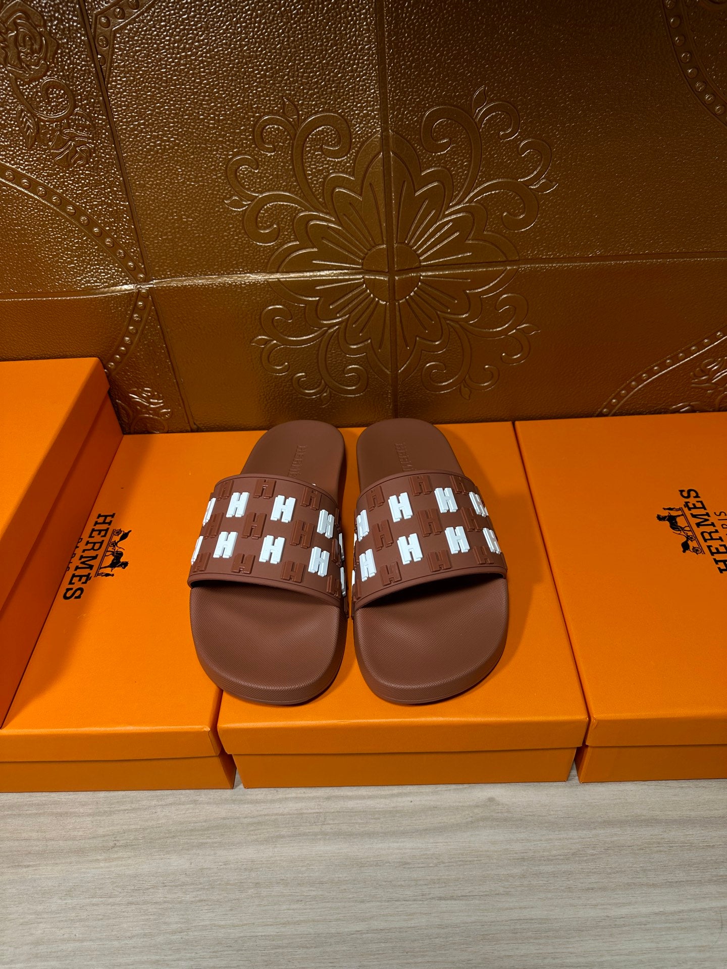 Hermes leather slide sandals in dark brown with patterned strap and open toe