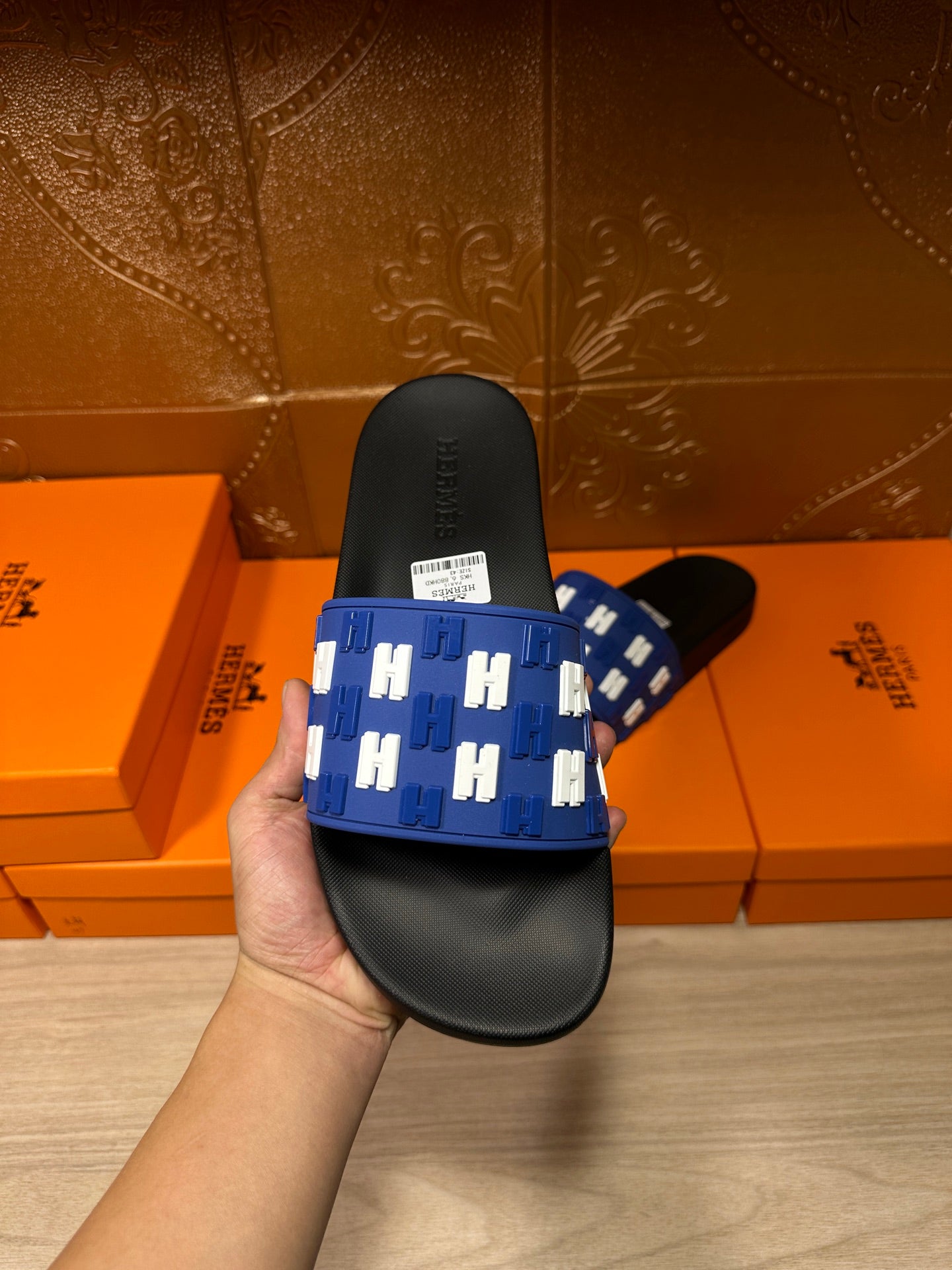 Hermes slide sandals held: blue strap with white H motifs over black sole