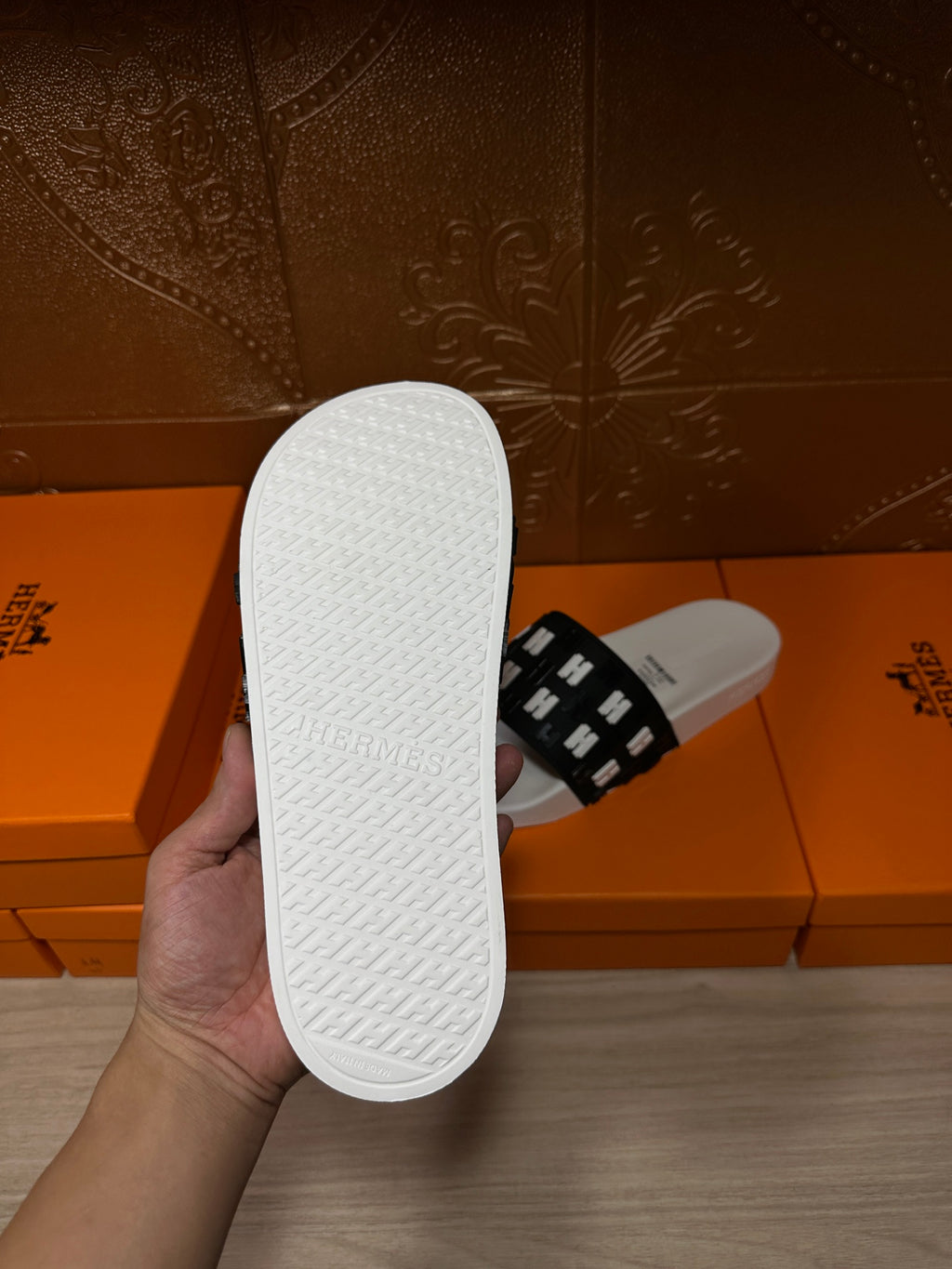 Hermes slide sandals, outsole view: textured white sole with black H-strap