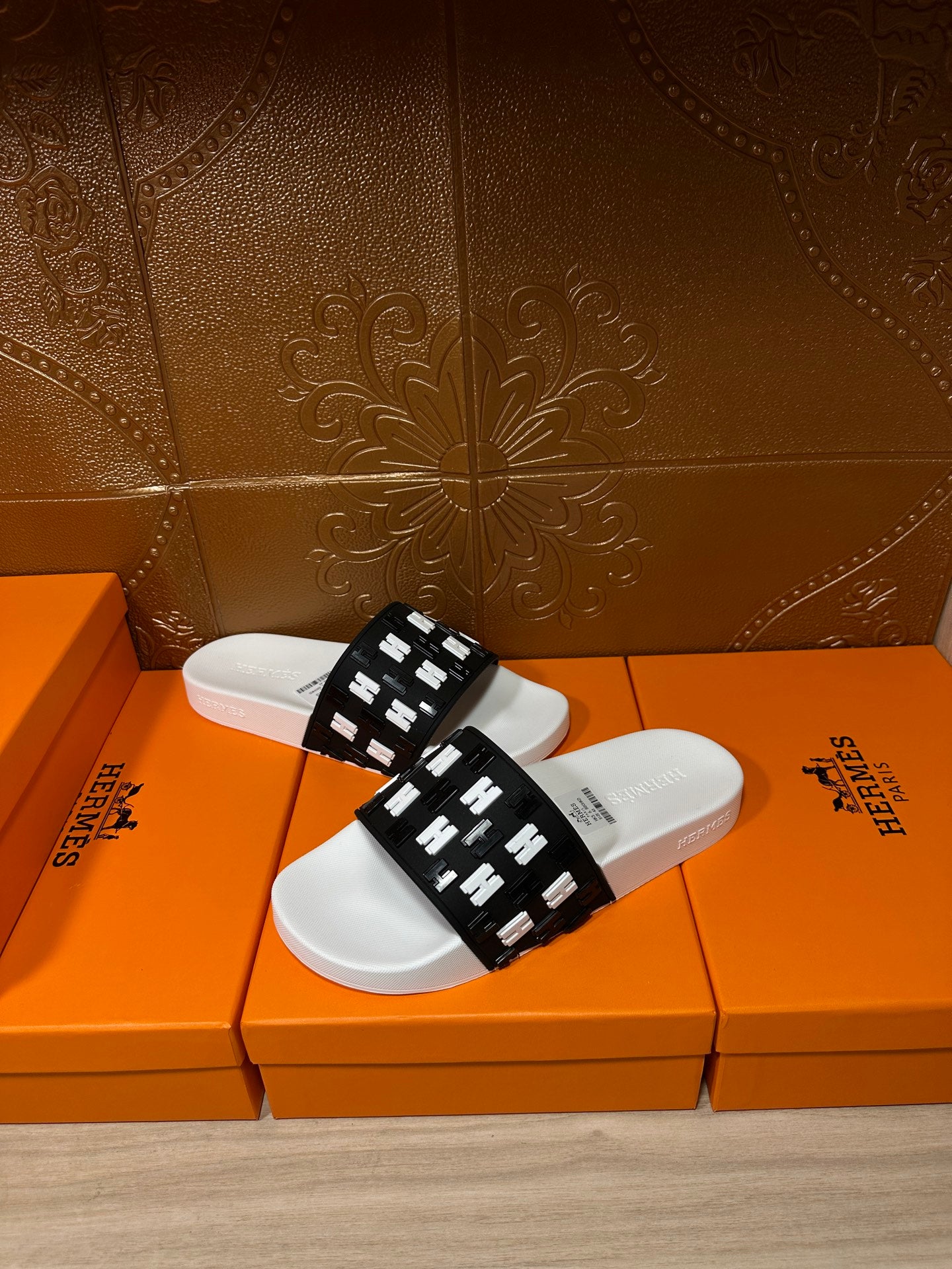 Hermes slide sandals, black slide strap with repeating H pattern, white footbed
