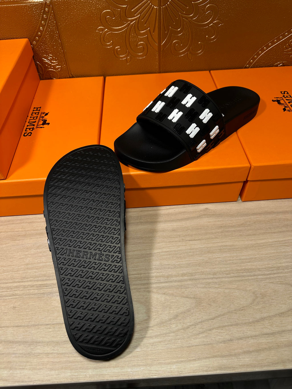 Black slide sandal outsole with textured tread and raised pattern