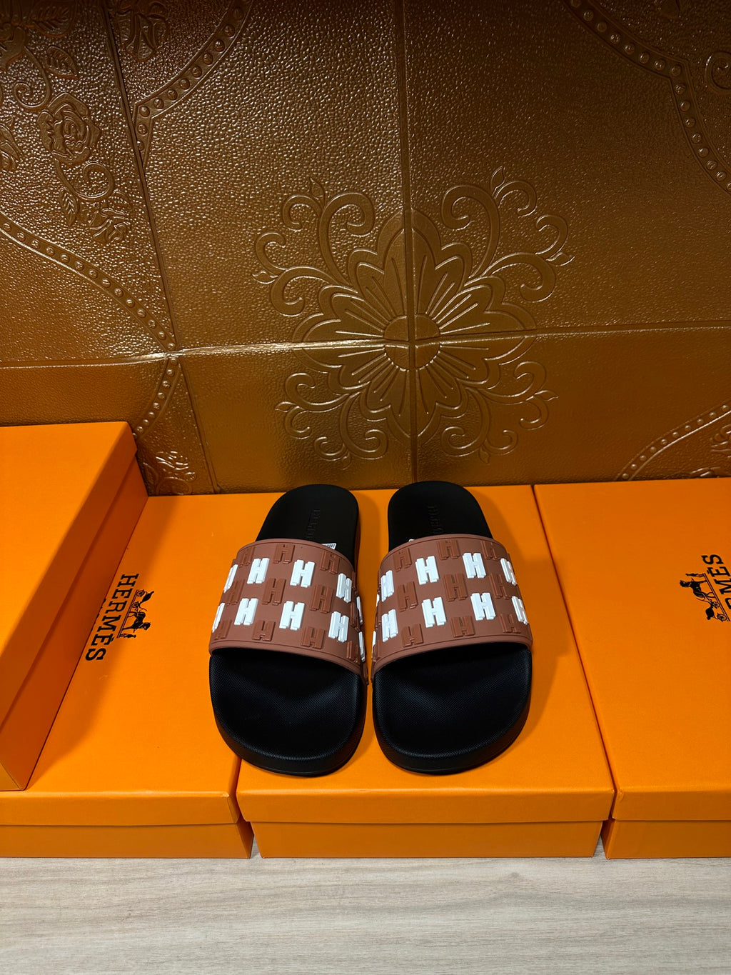 Hermes slide sandals with black footbed and tan strap with white patterned H accents