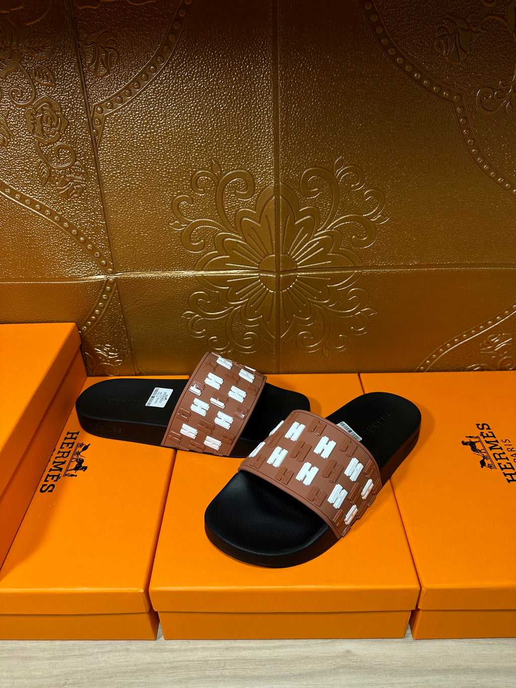 Hermes slide sandals pair, black footbeds with tan strap and white H motif band