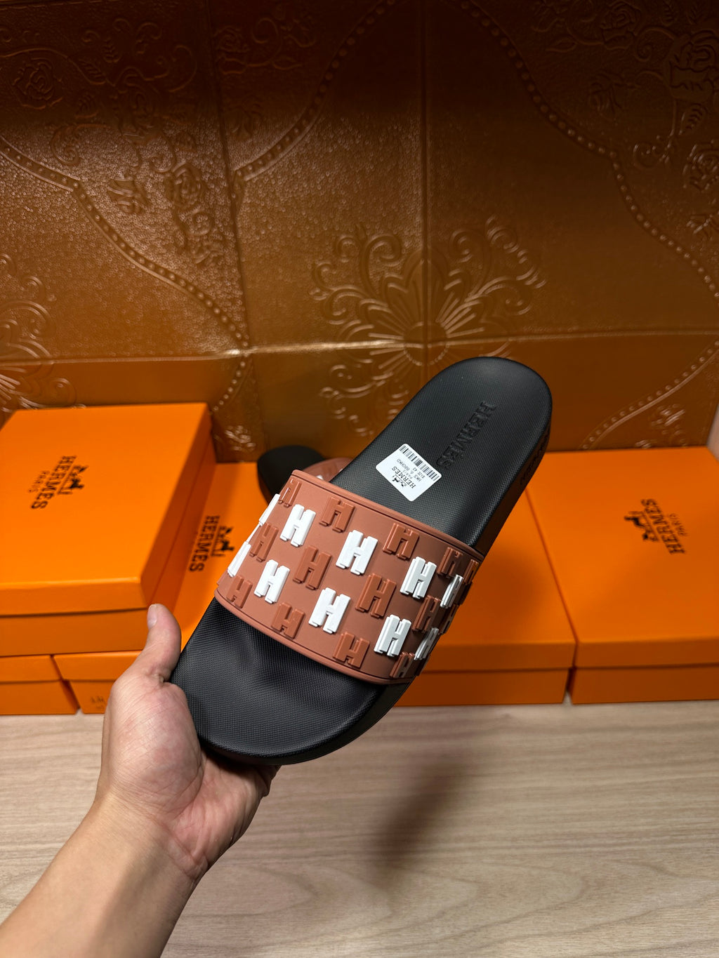 Hermes slide sandal held, black upper footbed and tan strap with white H motif