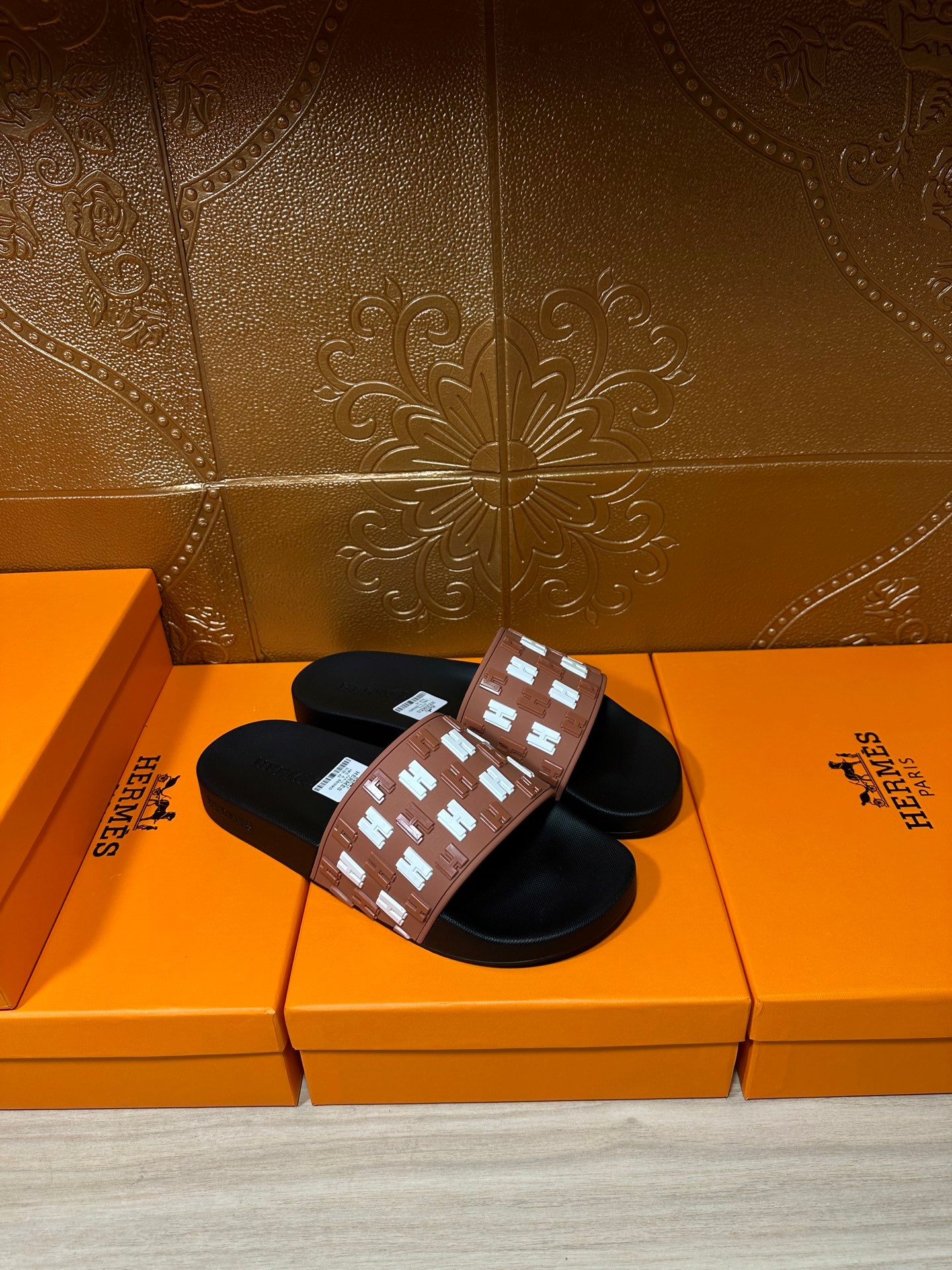 Hermes slide sandals, tan strap detail with repeating white H pattern on black base