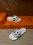 Hermes sandals, white slide sandal with black H logo strap, angled