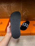 Black rubber sandal sole with textured pattern, slide heel shown