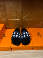 Hermes black sandals with navy strap and white H-pattern