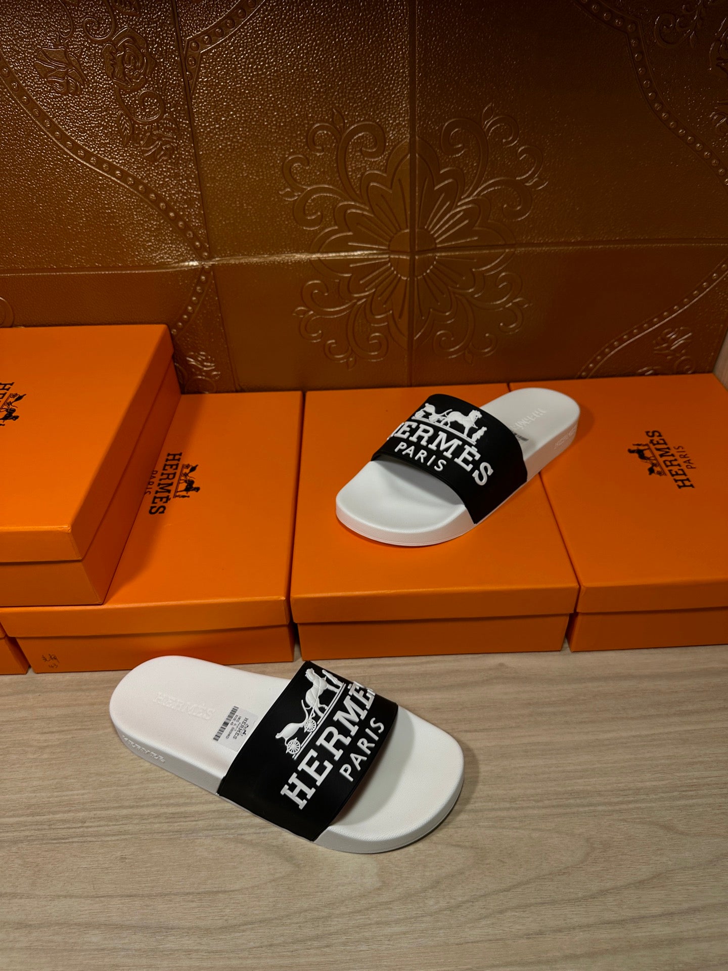 Hermes slide sandals with white footbed and black strap featuring Hermes Paris branding