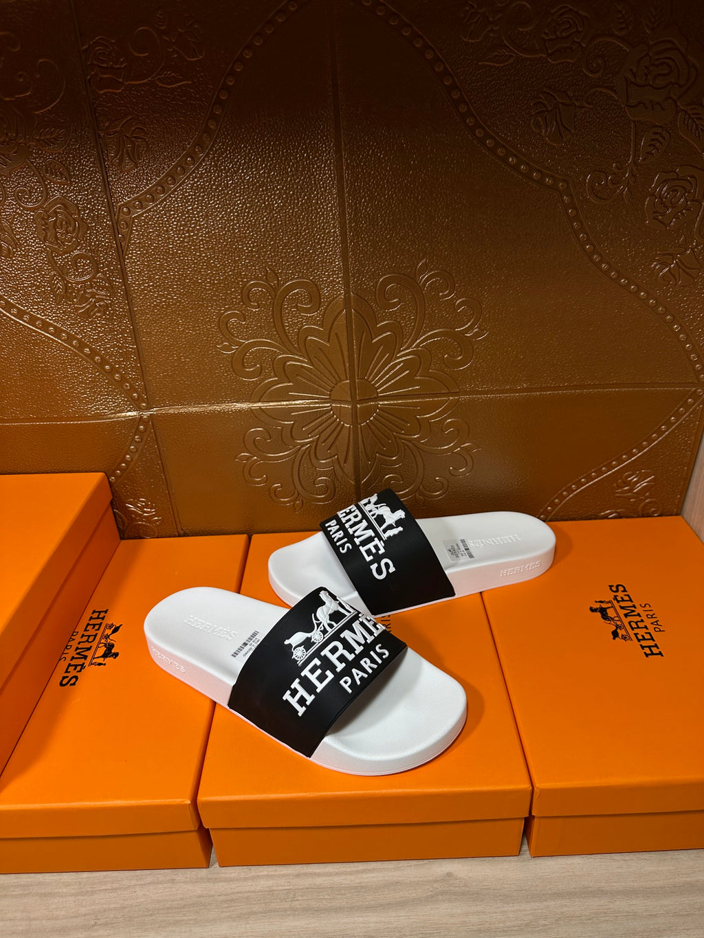 Hermes slide sandals, black strap with Hermes Paris logo over white footbed