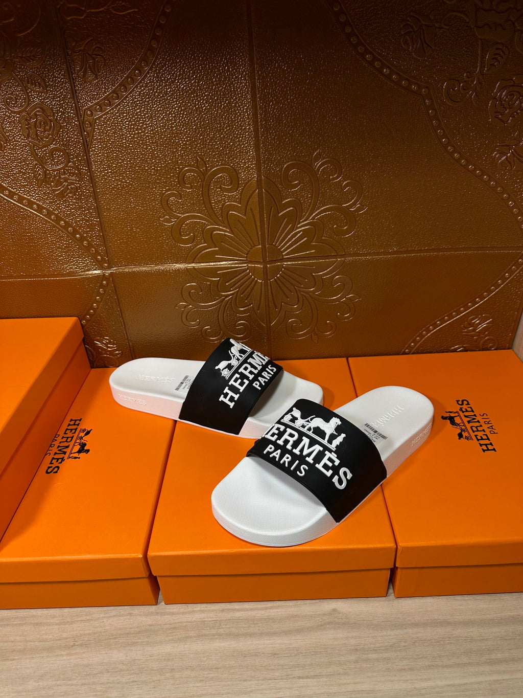 Hermes slide sandals, white slides with black strap and Hermes Paris text