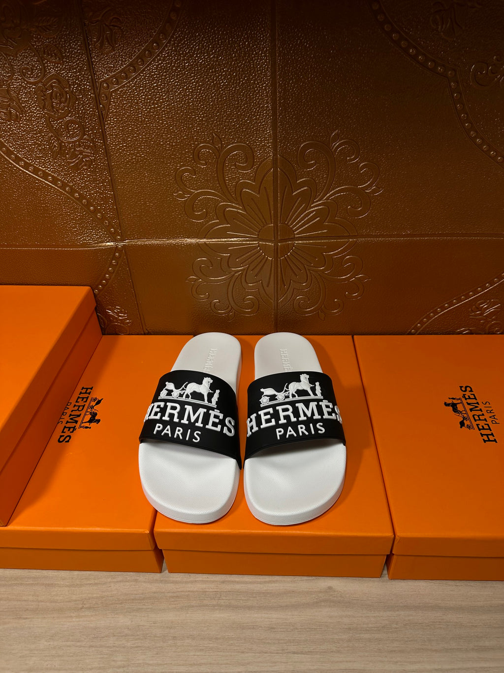 Hermes slide sandals with white footbed and black logo band strap