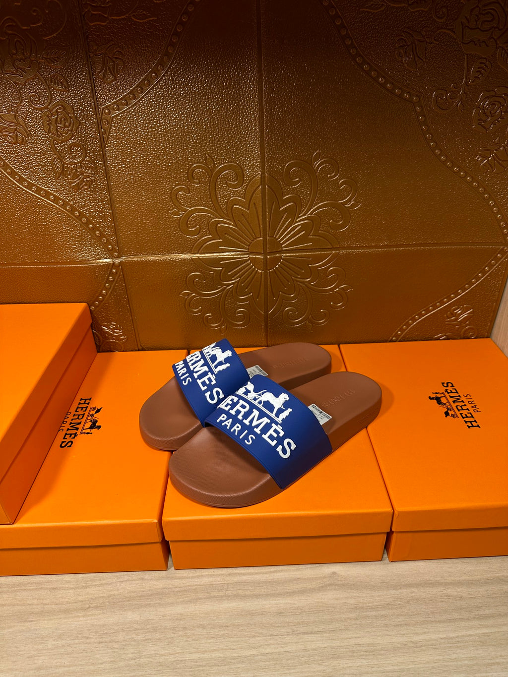 Brown slide sandals with blue Hermes Paris strap, pair view