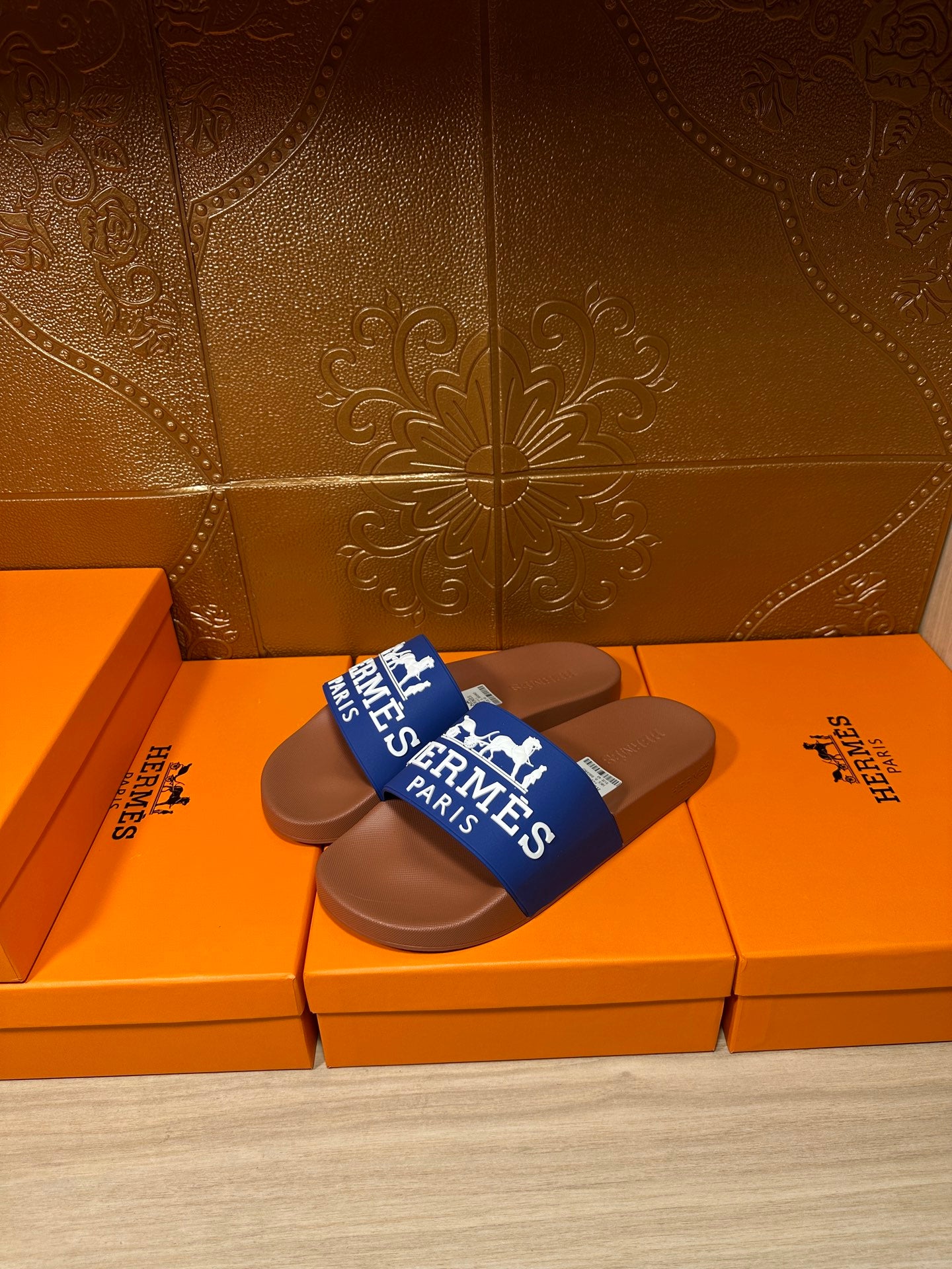 Brown slide sandals with blue Hermes Paris strap, pair view
