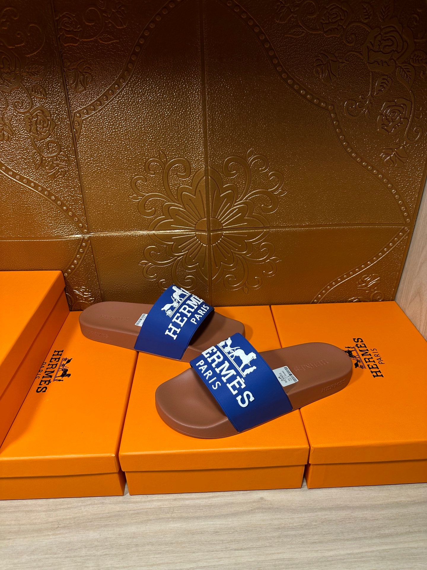 Brown slide sandals with blue Hermes Paris strap, side view