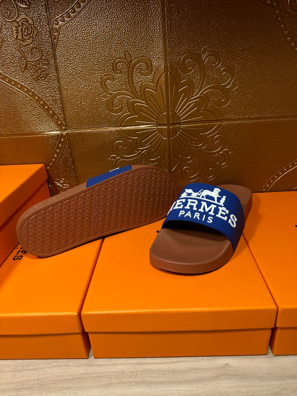 Brown slide sandal with textured sole and blue Hermes Paris strap