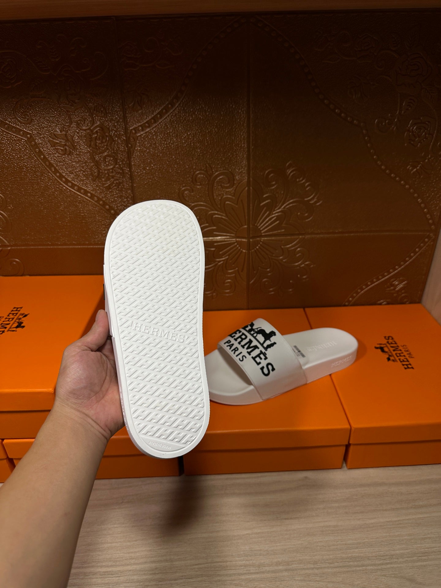 White slide sandal with textured sole, Hermes Paris logo strap