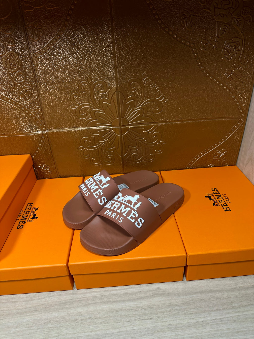Brown slide sandals, white HERMES PARIS logo on wide strap