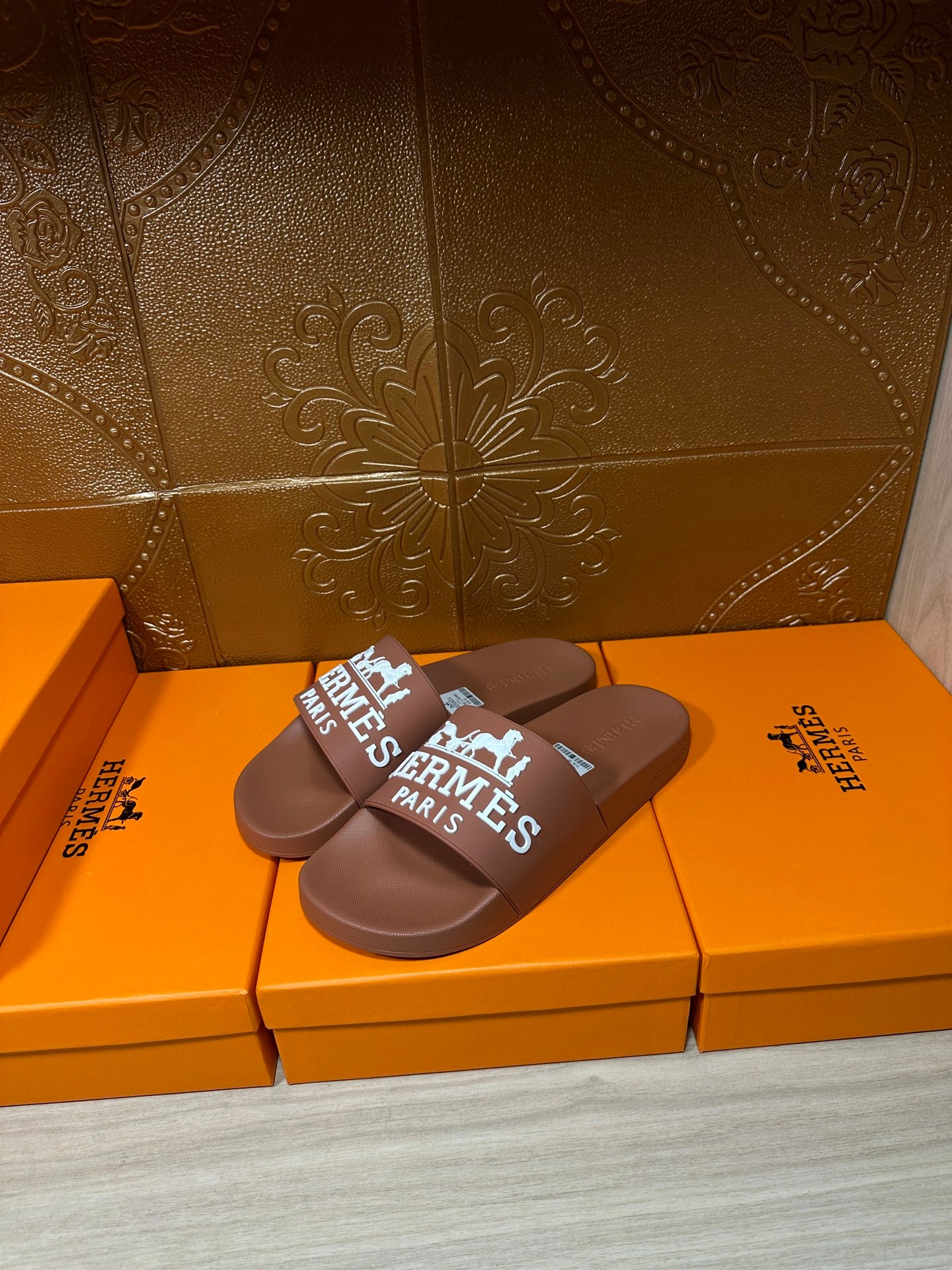 Brown slide sandals, white HERMES PARIS logo on wide strap