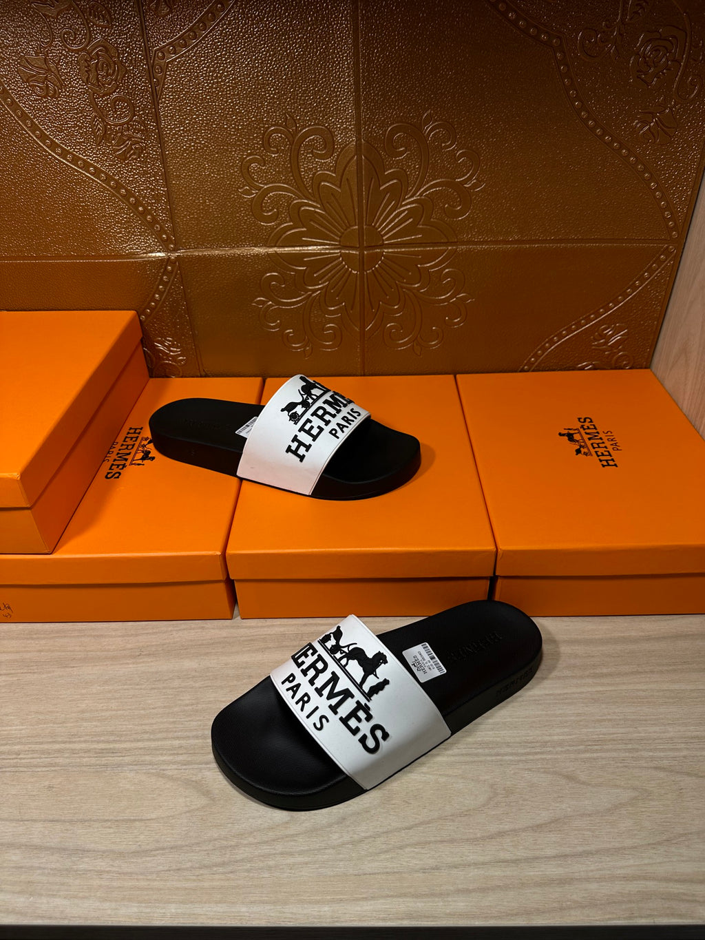 Hermes sandals with black slides and white top strap displaying Hermes Paris