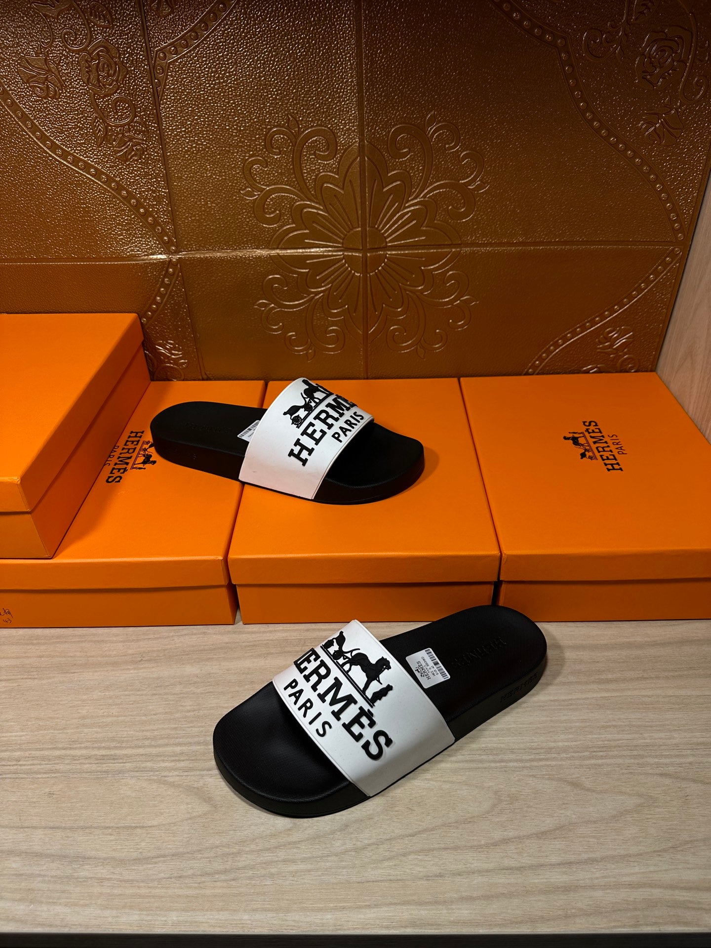 Hermes sandals with black slides and white top strap displaying Hermes Paris