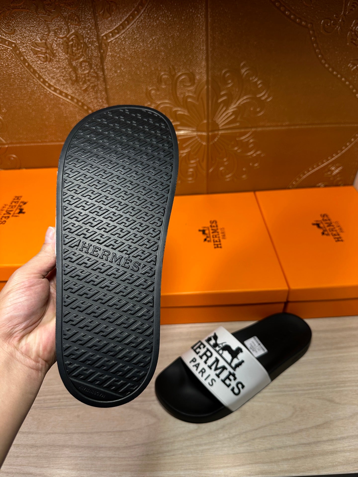 Hermes slide sandals: textured black outsole and white logo strap