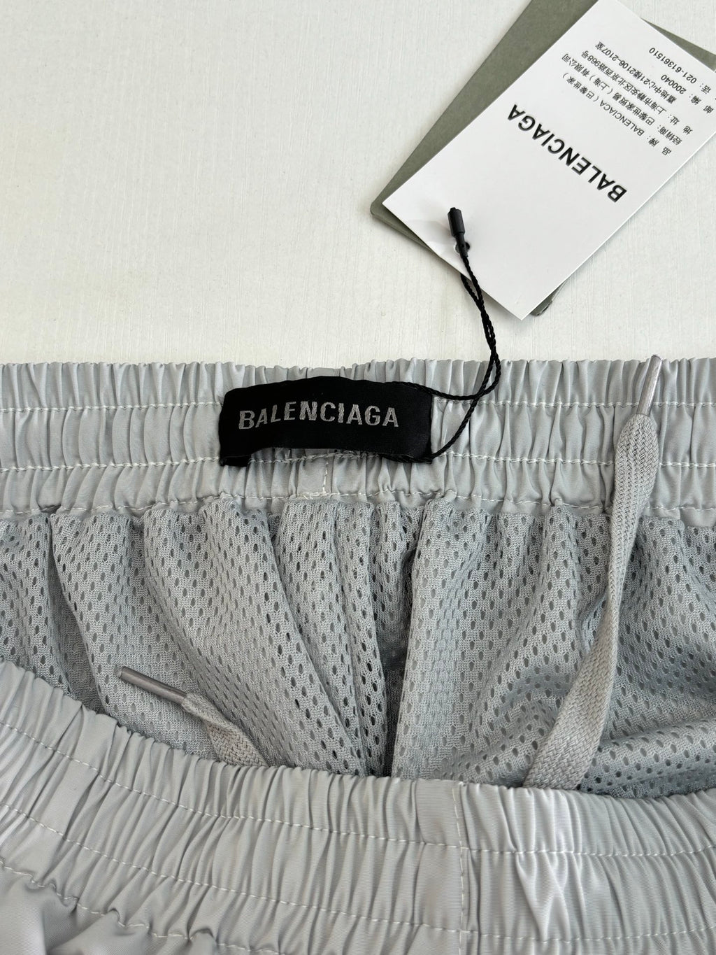 Balenciaga shorts with black logo label at waistband and patterned inner panel