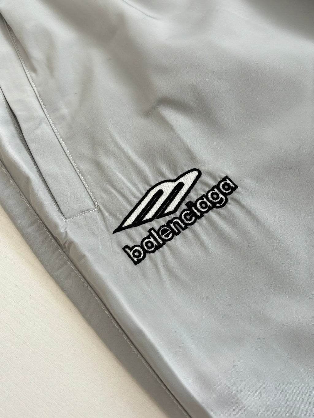 Light blue Balenciaga logo patch on the shorts leg with visible stitched seams