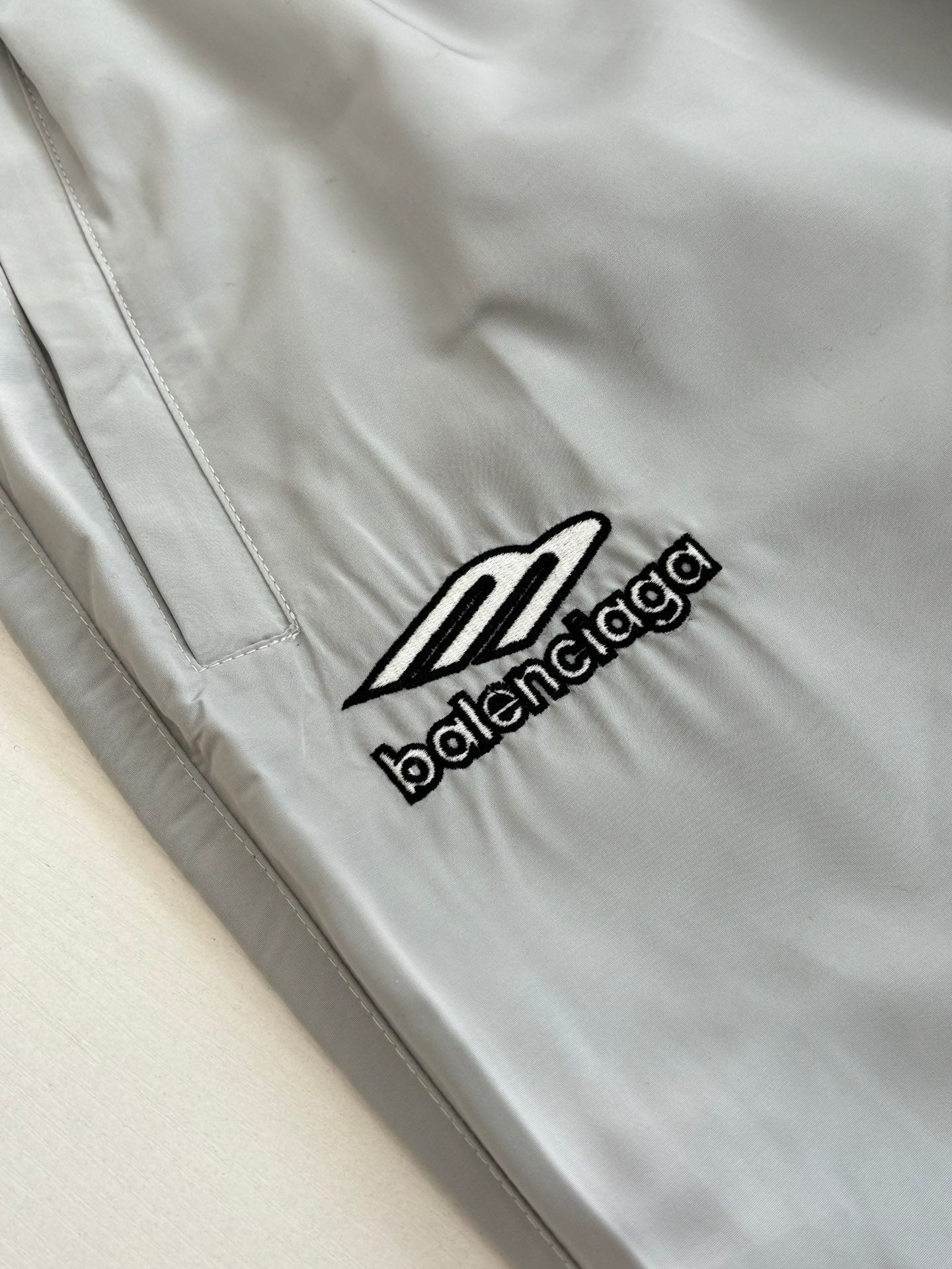 Light blue Balenciaga logo patch on the shorts leg with visible stitched seams