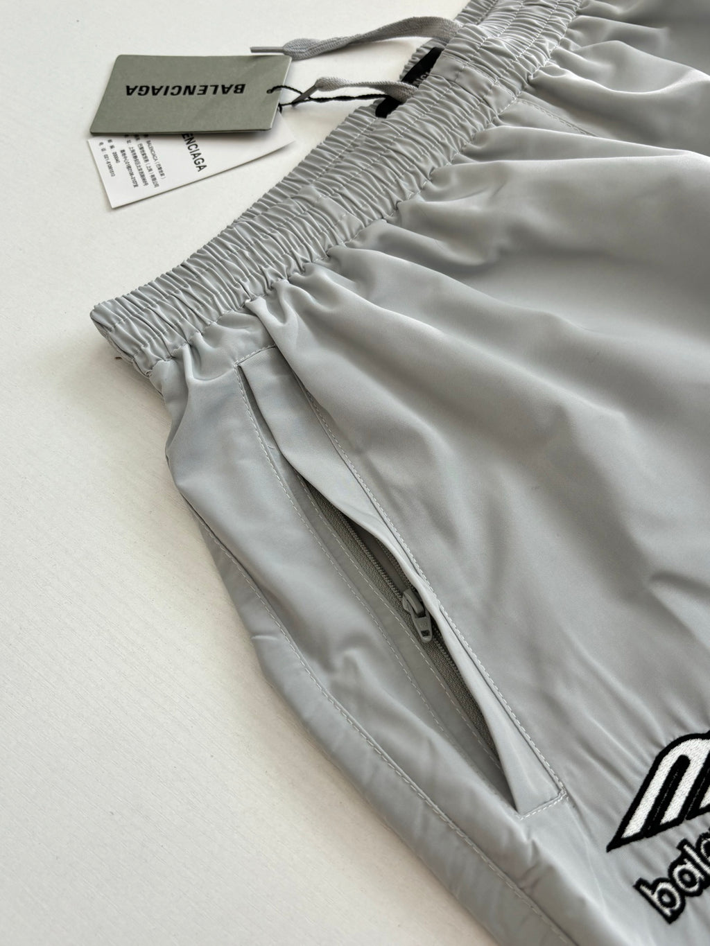 Light blue Balenciaga shorts with smocked elastic waist and small logo embroidery detail