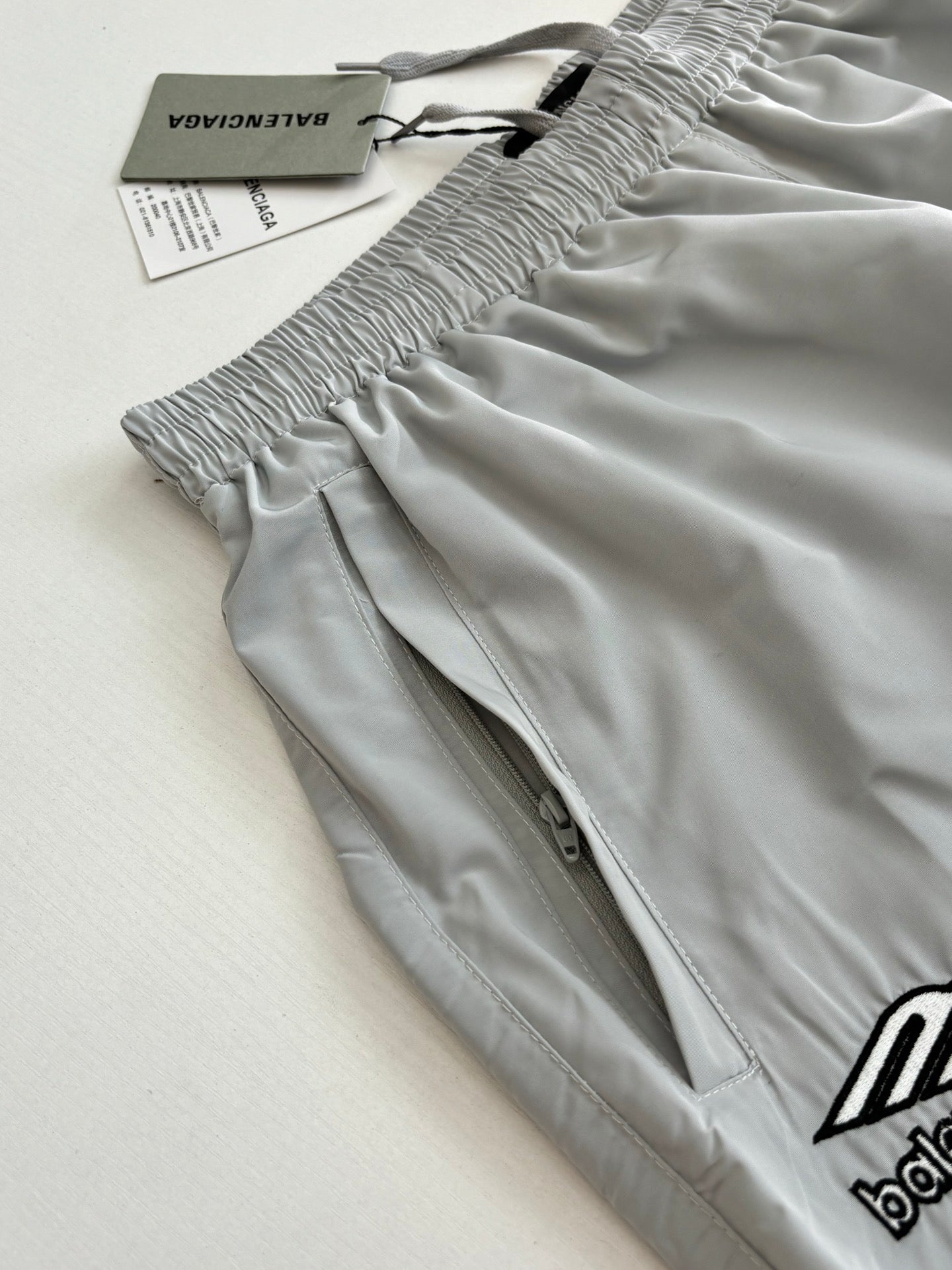 Light blue Balenciaga shorts with smocked elastic waist and small logo embroidery detail