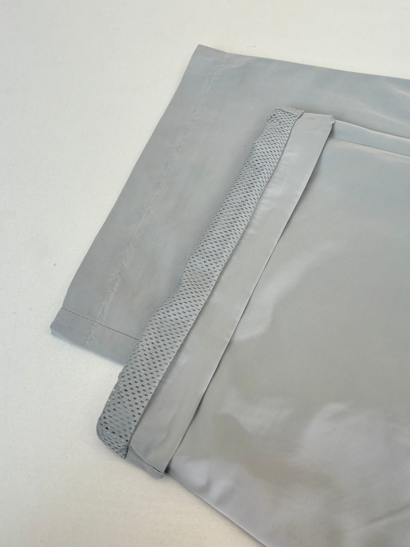 Light blue shorts with textured stripe detail on the hem, laid flat