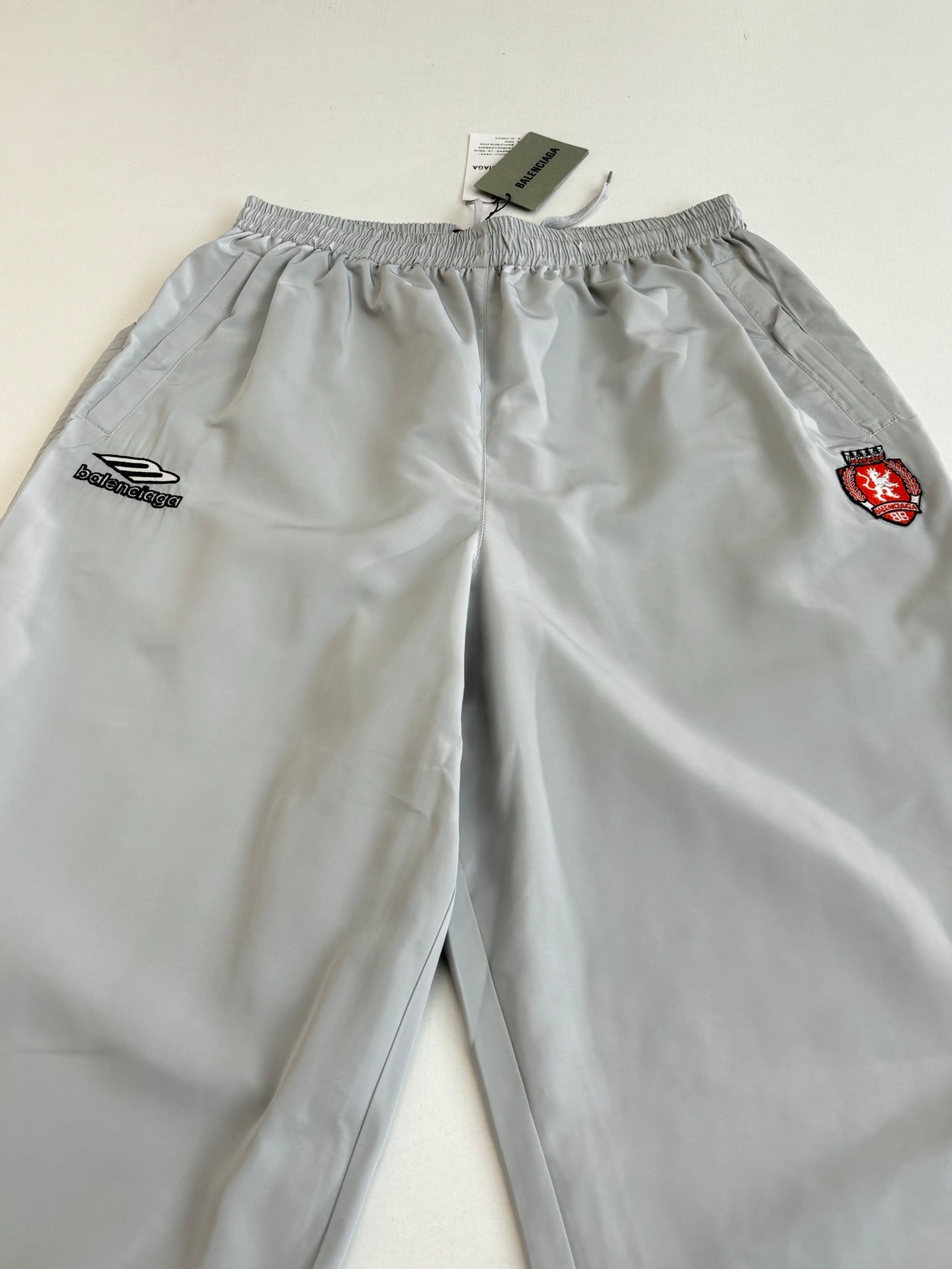 Light blue Balenciaga shorts with elastic waistband and embroidered logo patches