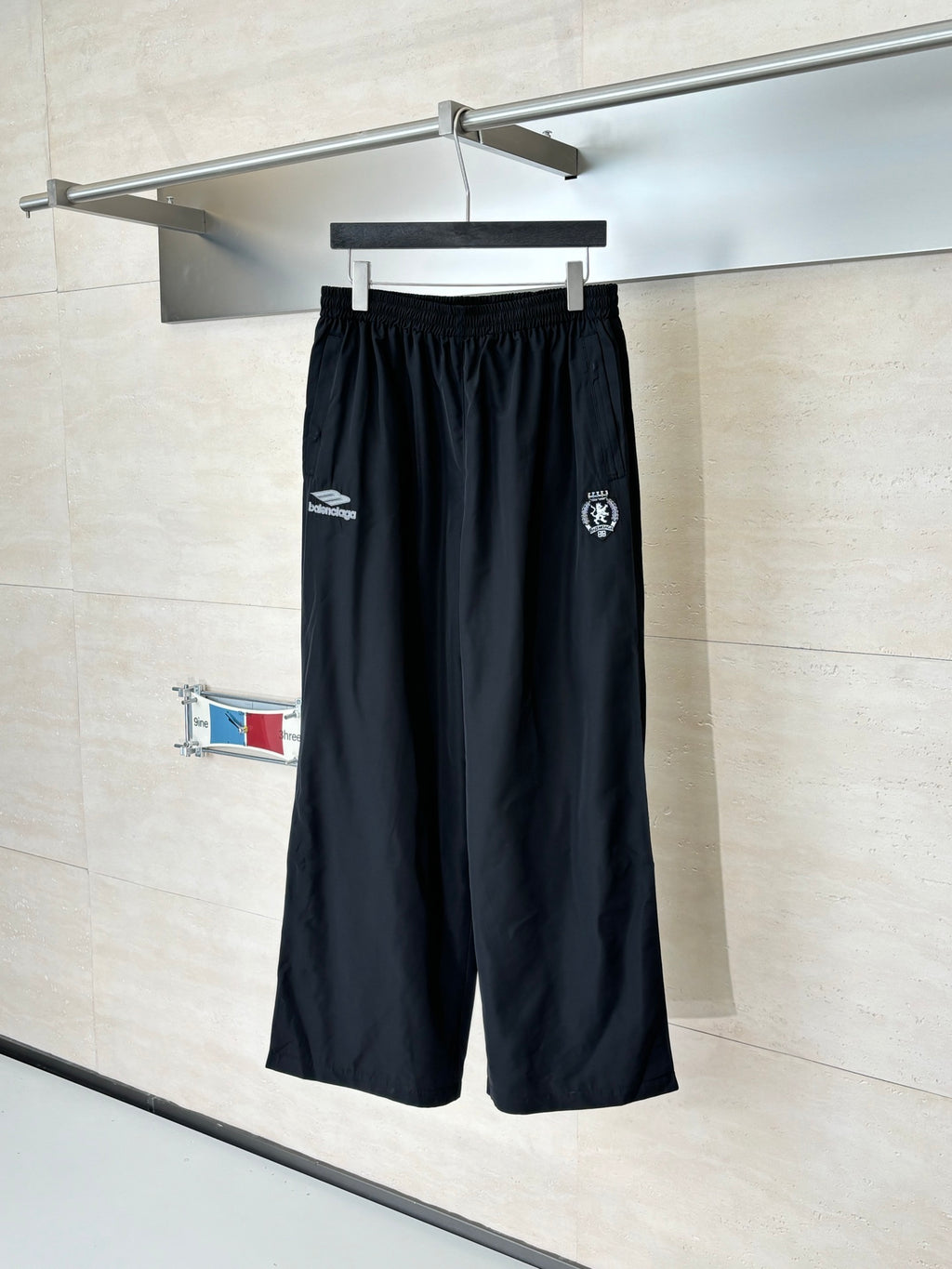 Black Balenciaga track pants with elastic waistband and side logo patches