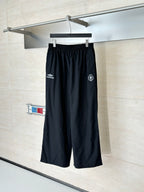 Black Balenciaga track pants with elastic waistband and side logo patches