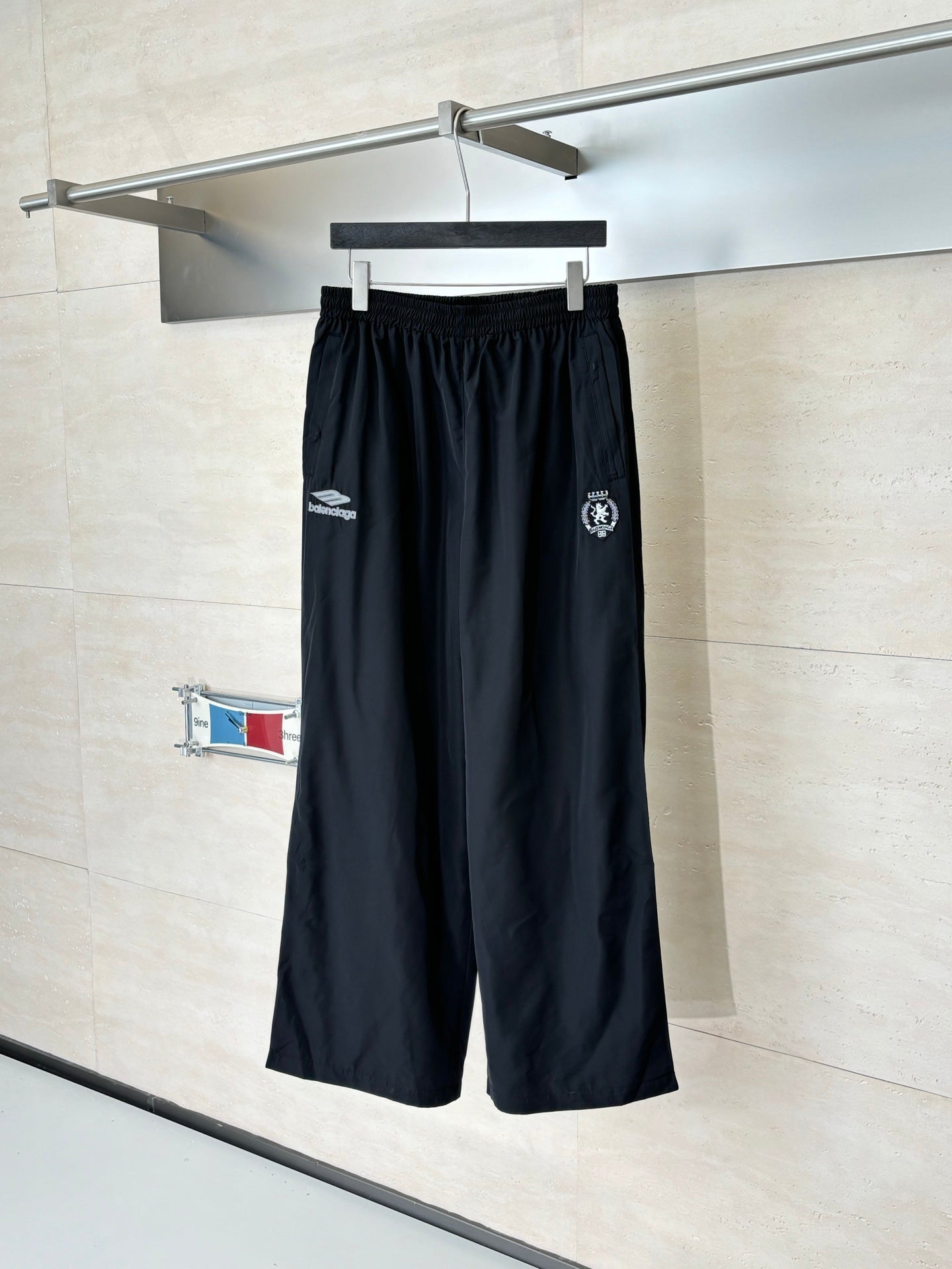 Black Balenciaga track pants with elastic waistband and side logo patches