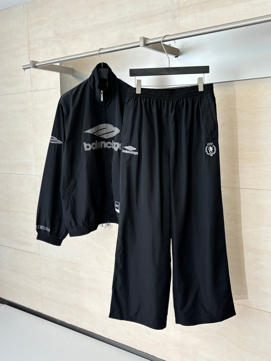 Black Balenciaga track pants with elastic waistband and side crest patch