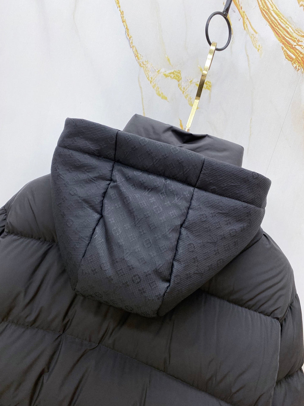 Dark gray puffer jacket hood close-up with textured quilting