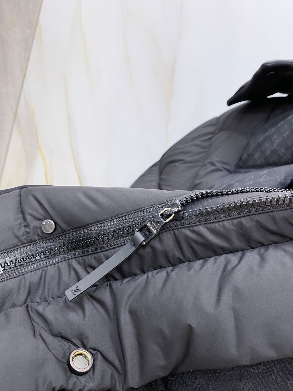 Dark gray puffer jacket front zipper with hanging tag and snap pocket