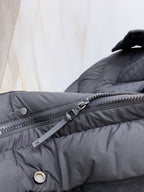 Dark gray puffer jacket front zipper with hanging tag and snap pocket