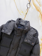 Dark gray puffer jacket with front placket, snap tabs, and LV chest logo