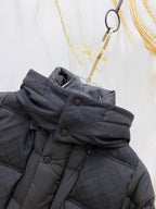 Dark gray puffer jacket collar detail with snap buttons and straps