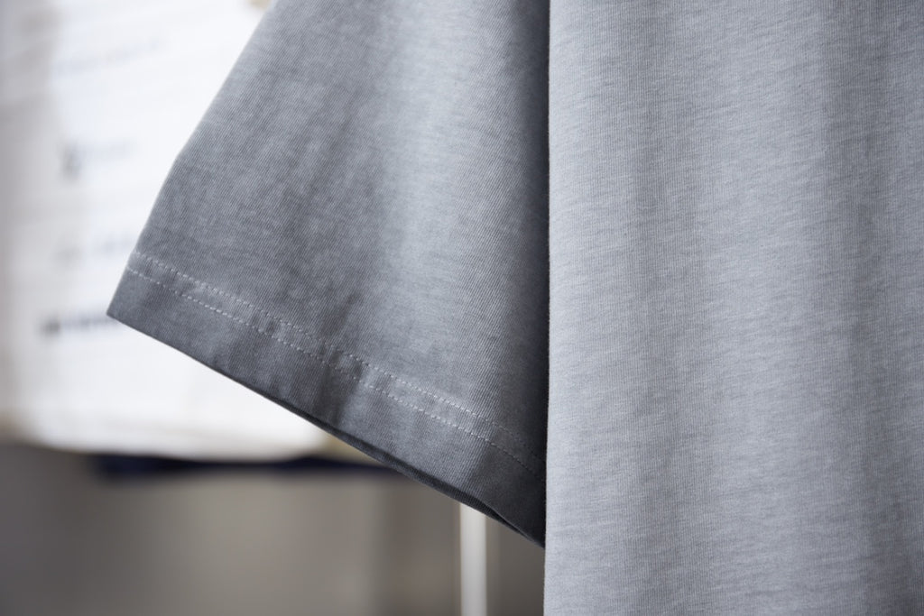 Light blue T-shirt sleeve and hem with clean stitched edge