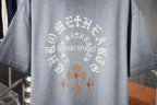 Light blue short-sleeve T-shirt back with large circular cross graphic
