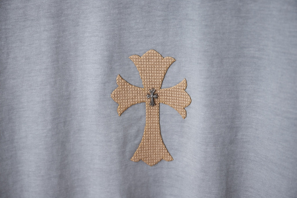 Light blue T-shirt with detailed cross emblem applique at center