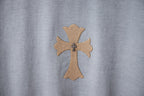 Light blue T-shirt with detailed cross emblem applique at center