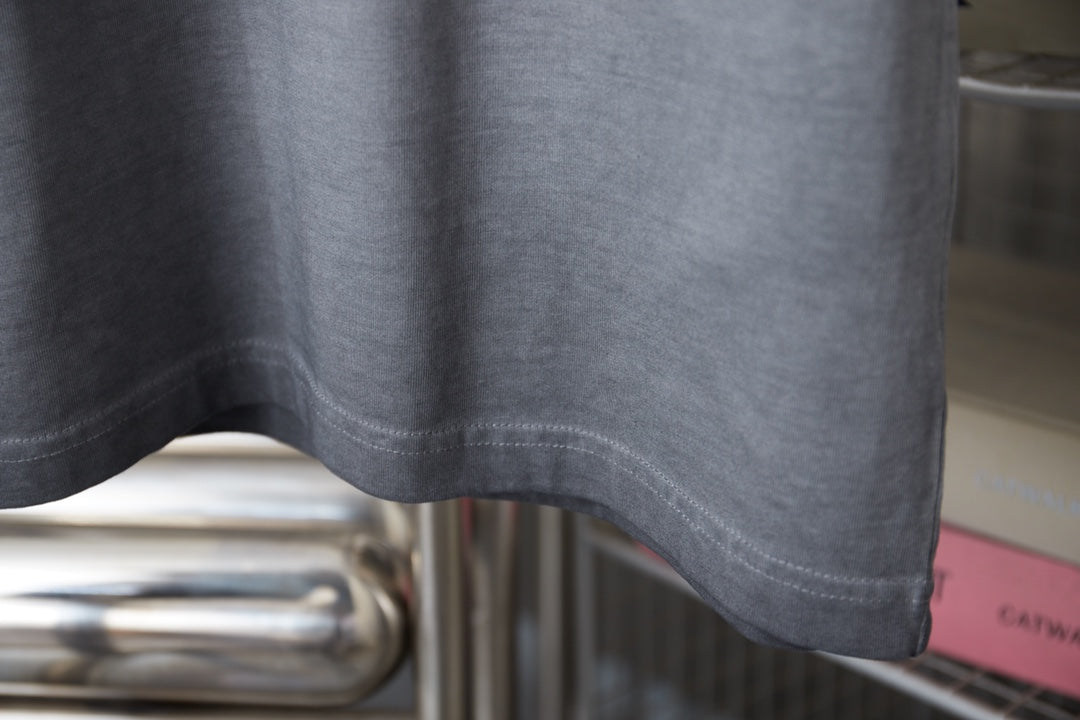 Light blue T-shirt lower hem with stitched seam detail