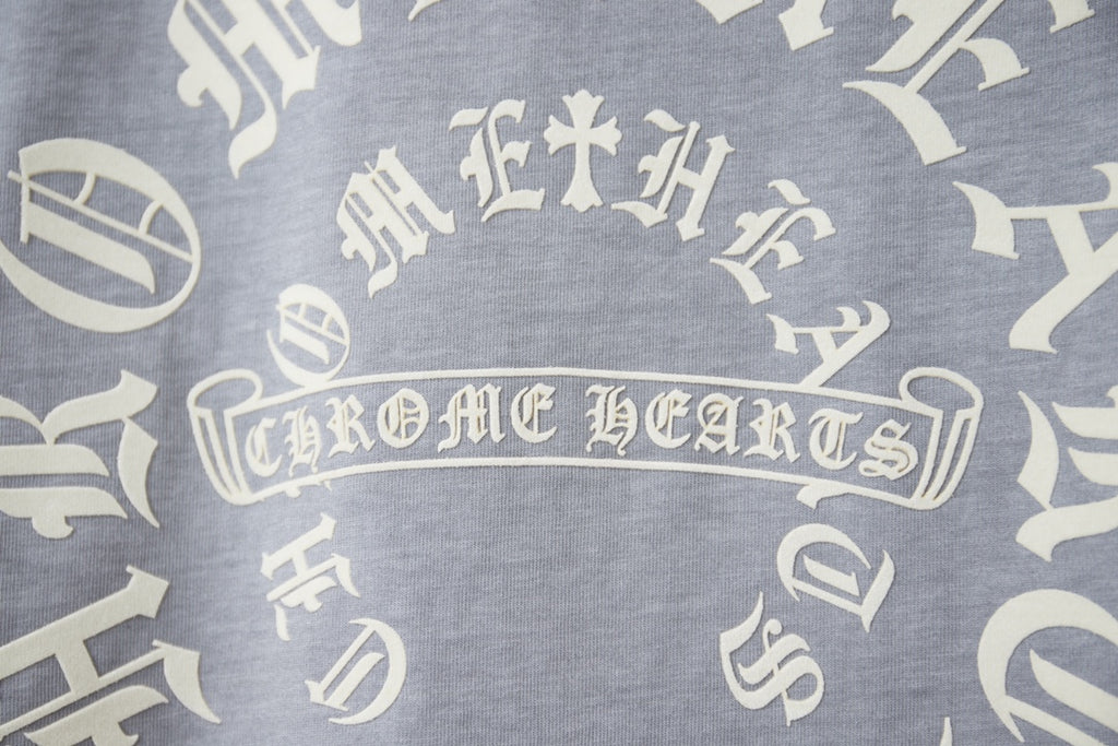 Close-up of white circular text and icon print on light blue T-shirt