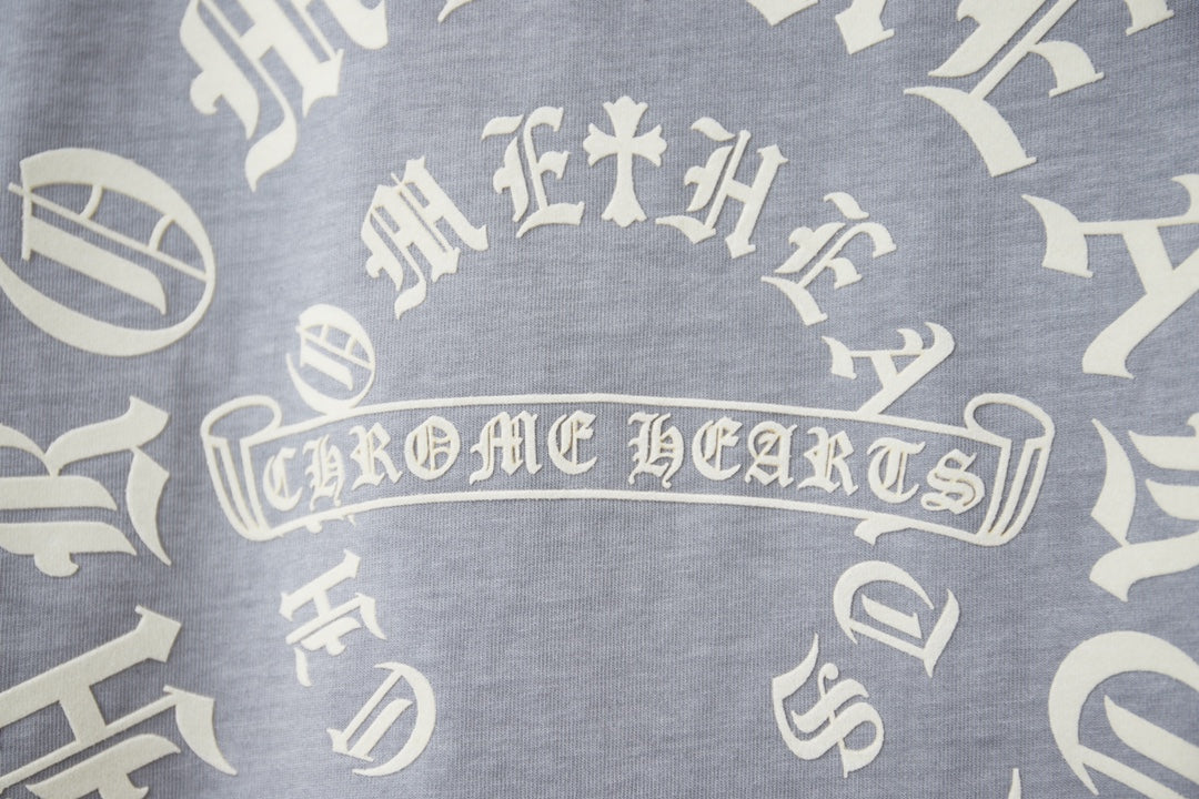 Close-up of white circular text and icon print on light blue T-shirt