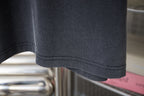 Dark gray T-shirt sleeve hem with double-stitched seam